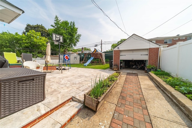 67-15 214th St, Bayside, NY 11364 - fenced backyard featuring a playground, a patio area, a garage, and a storage shed