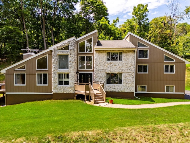 4 S Hill Rd, Tomkins Cove, NY 10986 - rear view of house with stone siding, a lawn, a wooden deck, and view of wooded area