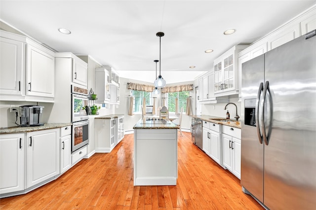 4 S Hill Rd, Tomkins Cove, NY 10986 - kitchen featuring appliances with stainless steel finishes, a center island, white cabinetry, light wood-style floors, and glass insert cabinets