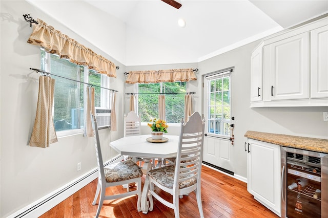4 S Hill Rd, Tomkins Cove, NY 10986 - dining room with wine cooler, light wood-type flooring, a baseboard heating unit, a bar, and cooling unit