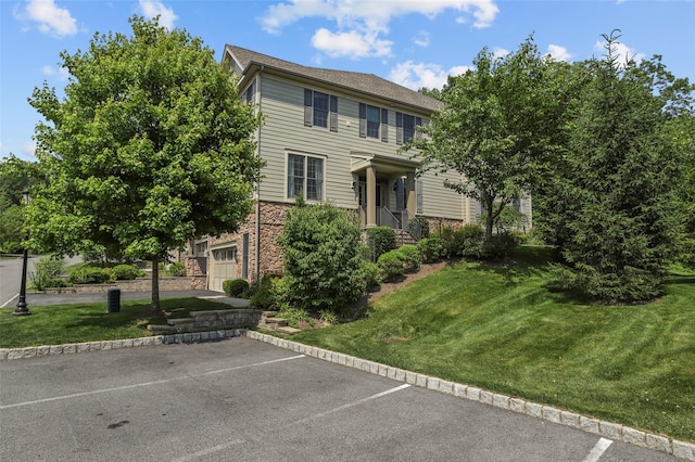 8 Langeloth Dr, Cortlandt Manor, NY 10567 - colonial home featuring uncovered parking, a front yard, and stone siding