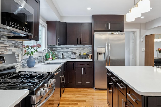 7 Nantucket Ln, Deer Park, NY 11729 - kitchen featuring appliances with stainless steel finishes, light wood finished floors, light countertops, tasteful backsplash, and recessed lighting