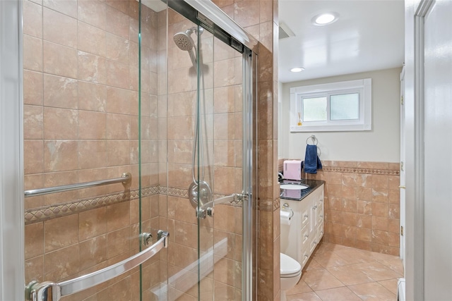 7 Nantucket Ln, Deer Park, NY 11729 - full bathroom with tile walls, a stall shower, vanity, tile patterned floors, and a wainscoted wall