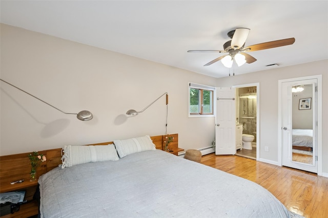 7 Nantucket Ln, Deer Park, NY 11729 - bedroom with light wood finished floors, ensuite bathroom, ceiling fan, and a baseboard radiator