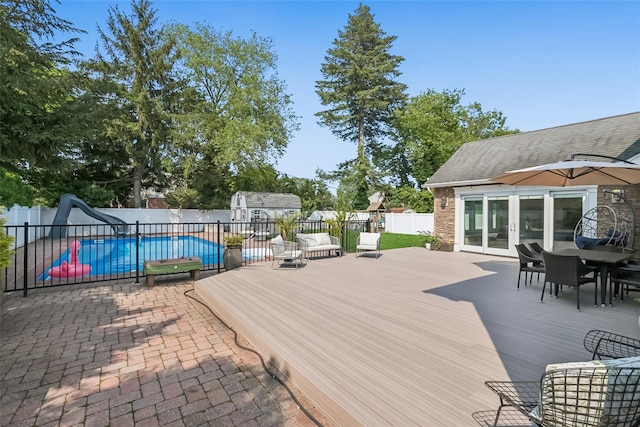 7 Nantucket Ln, Deer Park, NY 11729 - wooden terrace with french doors, a fenced backyard, a shed, and outdoor dining area