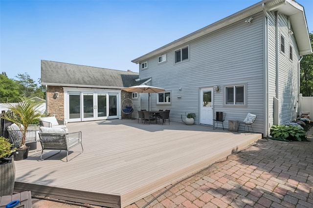 7 Nantucket Ln, Deer Park, NY 11729 - back of house featuring french doors, a deck, outdoor dining area, and stone siding