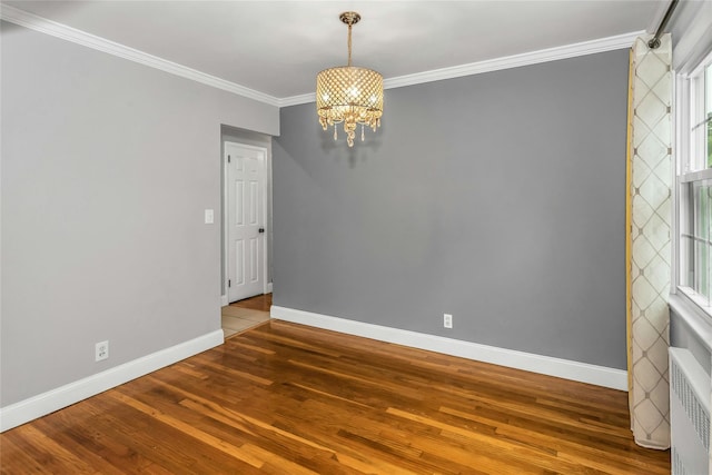 20 Spring Garden St, Valley Stream, NY 11580 - spare room with radiator heating unit, a chandelier, hardwood / wood-style flooring, and crown molding