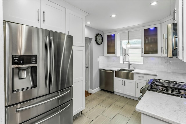 20 Spring Garden St, Valley Stream, NY 11580 - kitchen with appliances with stainless steel finishes, tasteful backsplash, white cabinetry, glass insert cabinets, and recessed lighting