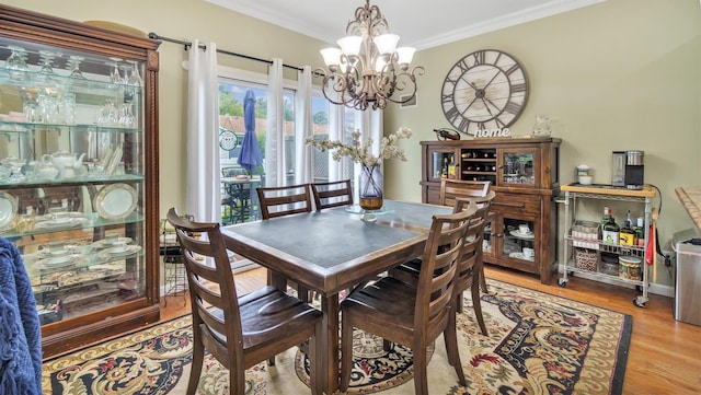 35 Terrace Ln Unit 35, Patchogue, NY 11772 - dining room with a chandelier, ornamental molding, and wood finished floors