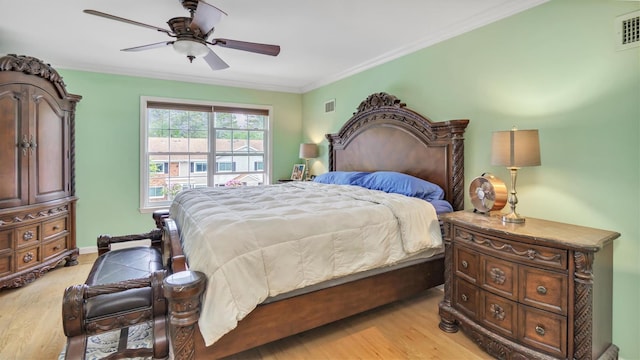 35 Terrace Ln Unit 35, Patchogue, NY 11772 - bedroom with light wood-style flooring, ornamental molding, and ceiling fan