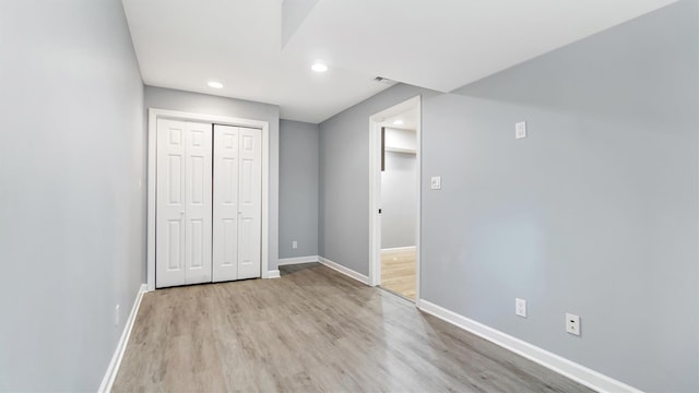 35 Terrace Ln Unit 35, Patchogue, NY 11772 - unfurnished bedroom featuring recessed lighting, light wood finished floors, and a closet