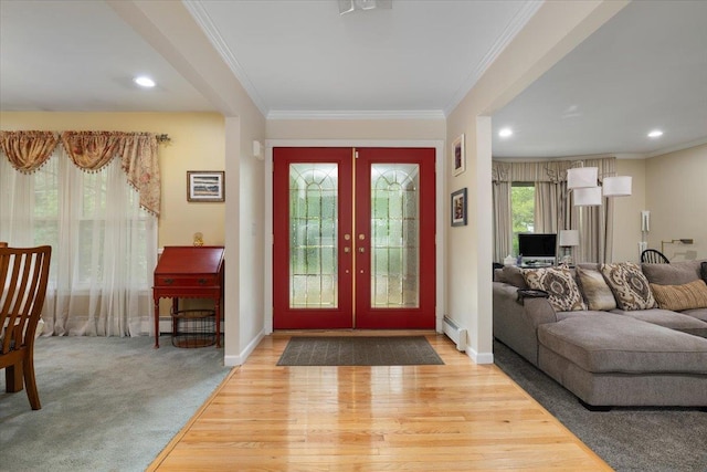 1 Ledgewood Cir E, Setauket, NY 11733 - foyer entrance featuring french doors, baseboard heating, crown molding, baseboards, and wood finished floors