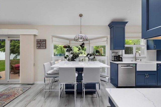 1 Ledgewood Cir E, Setauket, NY 11733 - kitchen featuring blue cabinets, stainless steel dishwasher, light wood-type flooring, decorative light fixtures, and a kitchen breakfast bar