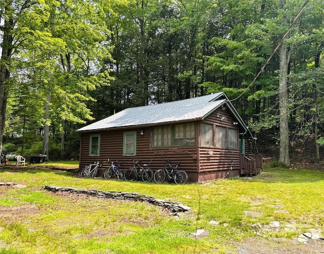 26 E Tusten, Smallwood, NY 12778 - view of side of property with log veneer siding, a lawn, roof with shingles, and a view of trees