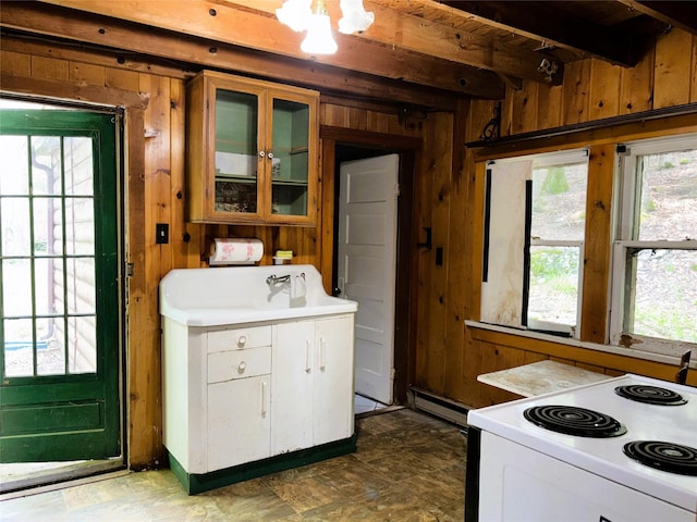 26 E Tusten, Smallwood, NY 12778 - kitchen featuring white electric stove, wooden walls, healthy amount of natural light, beam ceiling, and glass insert cabinets