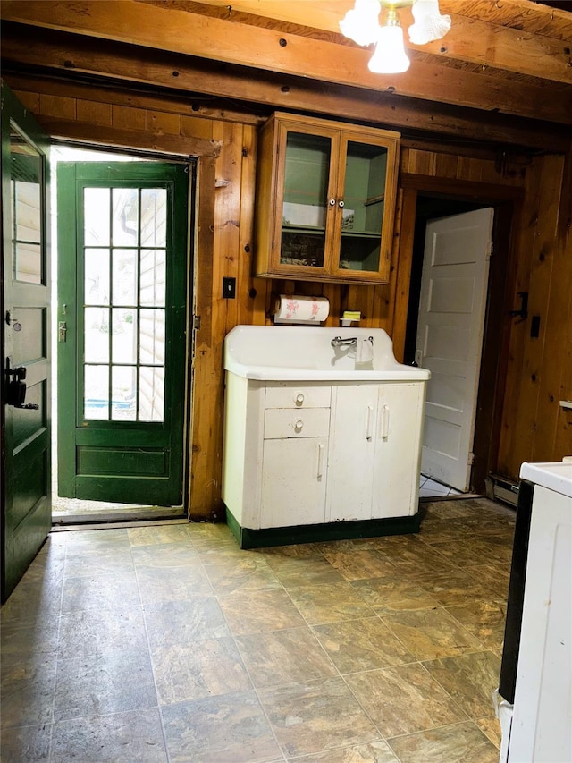 26 E Tusten, Smallwood, NY 12778 - kitchen with wooden walls, light countertops, glass insert cabinets, stove, and white cabinetry