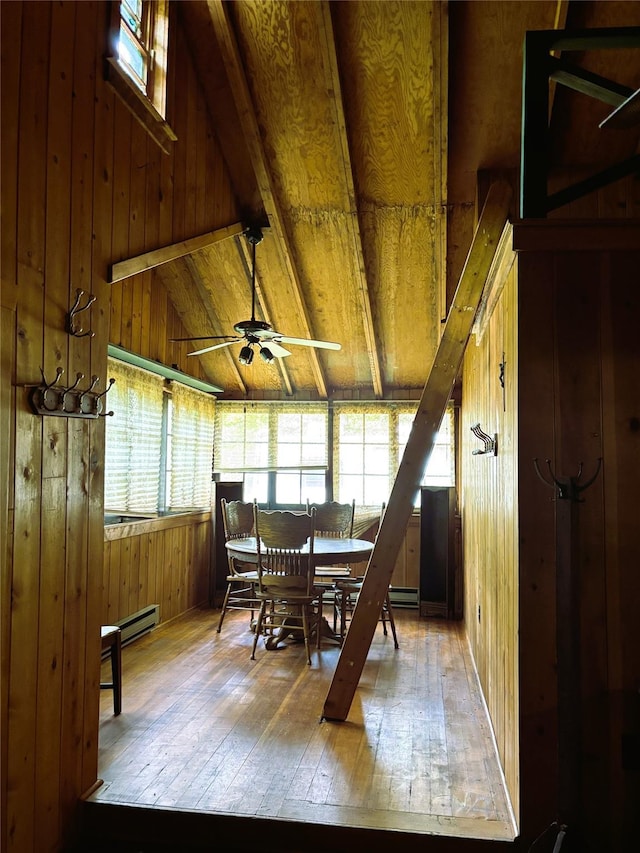 26 E Tusten, Smallwood, NY 12778 - dining space with wooden walls, hardwood / wood-style flooring, a ceiling fan, and baseboard heating
