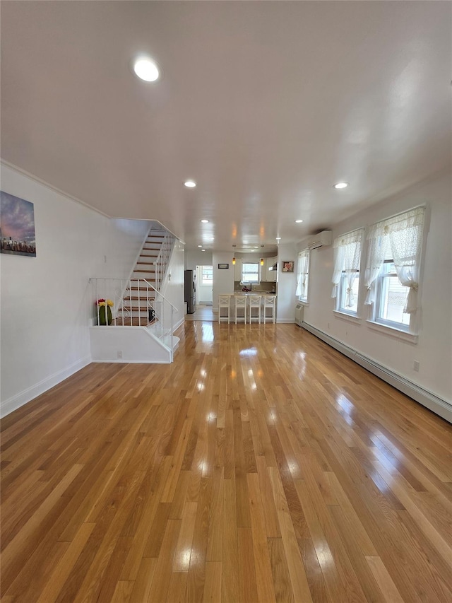244-59 89th Ave, Bellerose, NY 11426 - unfurnished living room featuring stairs, light wood finished floors, recessed lighting, and baseboard heating
