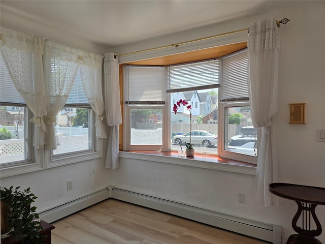 244-59 89th Ave, Bellerose, NY 11426 - unfurnished dining area featuring plenty of natural light, a baseboard heating unit, and light wood finished floors