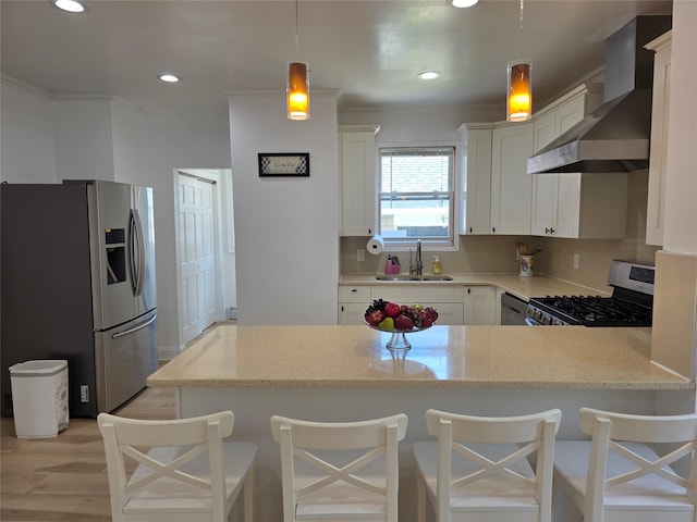 244-59 89th Ave, Bellerose, NY 11426 - kitchen featuring stainless steel appliances, wall chimney range hood, a peninsula, light stone countertops, and pendant lighting