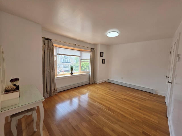 244-59 89th Ave, Bellerose, NY 11426 - empty room with a baseboard radiator and light wood finished floors