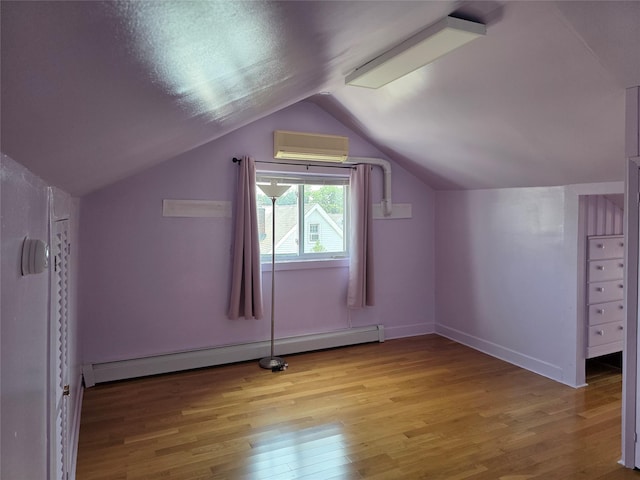 244-59 89th Ave, Bellerose, NY 11426 - bonus room featuring a wall mounted air conditioner, light wood-style flooring, vaulted ceiling, and a baseboard radiator
