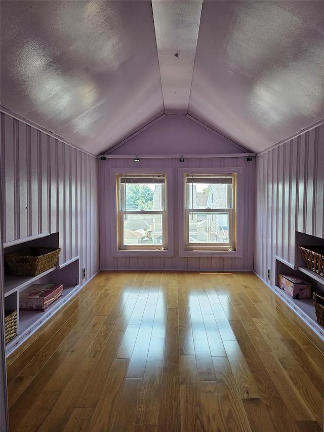 244-59 89th Ave, Bellerose, NY 11426 - unfurnished living room with hardwood / wood-style flooring, vaulted ceiling, and a textured ceiling
