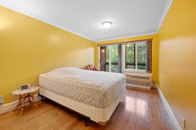 41 Wellington Ct Unit 1L, Staten Island, NY 10314 - bedroom with radiator heating unit, ornamental molding, baseboards, and wood finished floors