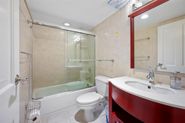 41 Wellington Ct Unit 1L, Staten Island, NY 10314 - full bathroom with tile walls, vanity, toilet, combined bath / shower with glass door, and recessed lighting