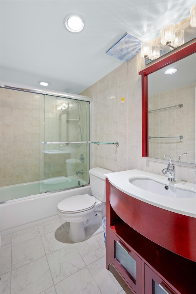 41 Wellington Ct Unit 1L, Staten Island, NY 10314 - bathroom featuring toilet, tile walls, vanity, shower / bath combination with glass door, and marble finish floors