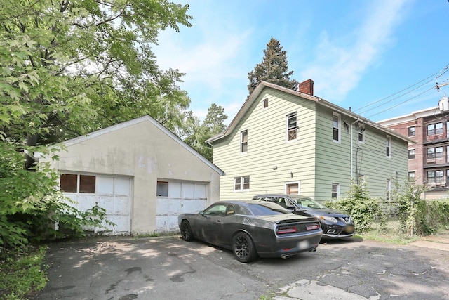 23 N Midland Ave, Nyack, NY 10960 - view of side of home with a chimney, a garage, and an outdoor structure