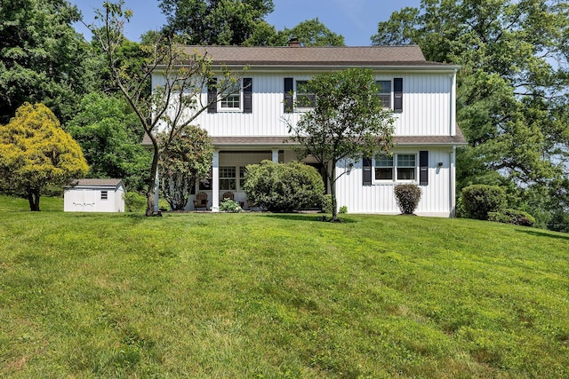 2022 Van Cortlandt Cir, Yorktown Heights, NY 10598 - view of front of house featuring a storage unit, a front yard, a chimney, and board and batten siding