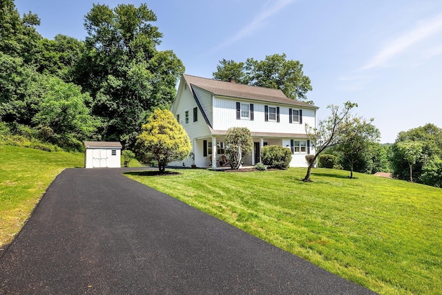 2022 Van Cortlandt Cir, Yorktown Heights, NY 10598 - view of front facade featuring a storage shed, a chimney, a front lawn, asphalt driveway, and a porch