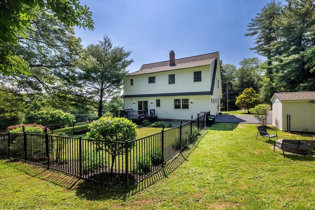 2022 Van Cortlandt Cir, Yorktown Heights, NY 10598 - rear view of property with a fenced backyard, a wooden deck, a chimney, and an outdoor structure