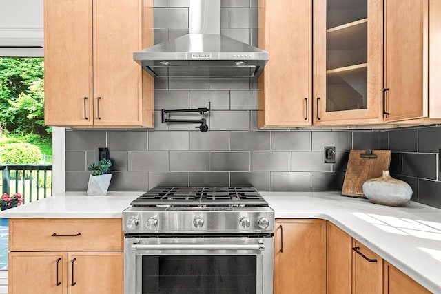 2022 Van Cortlandt Cir, Yorktown Heights, NY 10598 - kitchen with stainless steel range with gas stovetop, wall chimney range hood, light countertops, glass insert cabinets, and tasteful backsplash