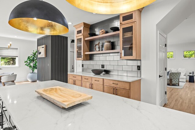 2022 Van Cortlandt Cir, Yorktown Heights, NY 10598 - kitchen with decorative backsplash, light wood finished floors, recessed lighting, brown cabinets, and glass insert cabinets