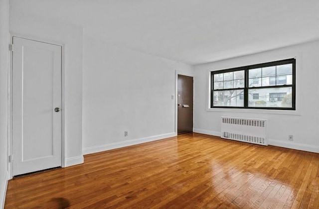 67-47 136th St Unit A, Kew Garden Hills, NY 11367 - unfurnished room with radiator and hardwood / wood-style flooring