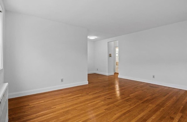 67-47 136th St Unit A, Kew Garden Hills, NY 11367 - empty room with light wood-type flooring and radiator
