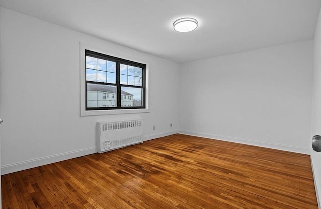 67-47 136th St Unit A, Kew Garden Hills, NY 11367 - spare room with radiator heating unit and wood finished floors