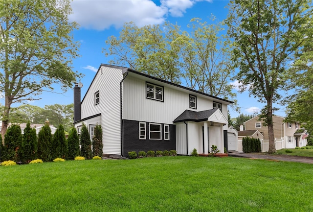 105 Julbet Dr, Sayville, NY 11782 - view of front of house featuring asphalt driveway, a garage, and a chimney