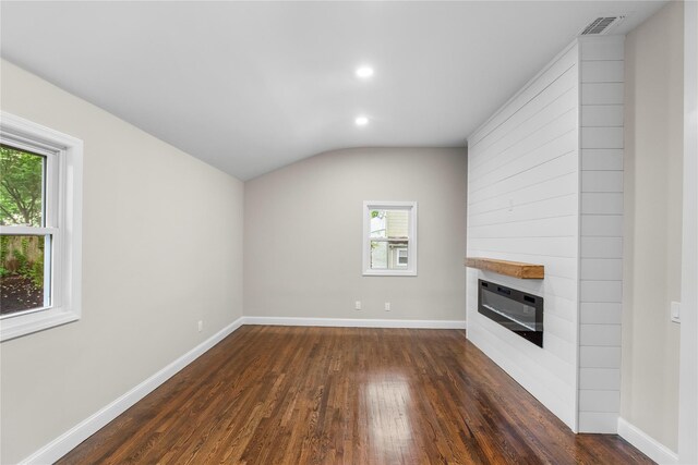 105 Julbet Dr, Sayville, NY 11782 - unfurnished living room featuring dark wood-style flooring, a fireplace, recessed lighting, and lofted ceiling
