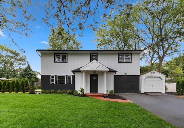 105 Julbet Dr, Sayville, NY 11782 - view of front of house featuring a front lawn, driveway, a garage, an outdoor structure, and brick siding