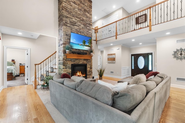 1 Hidden Hills Ct, Warwick, NY 10990 - living area featuring a towering ceiling, light wood-type flooring, a stone fireplace, stairs, and recessed lighting