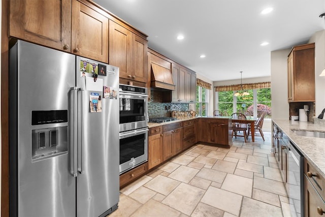 1 Hidden Hills Ct, Warwick, NY 10990 - kitchen featuring stainless steel appliances, custom exhaust hood, tasteful backsplash, light stone countertops, and a peninsula