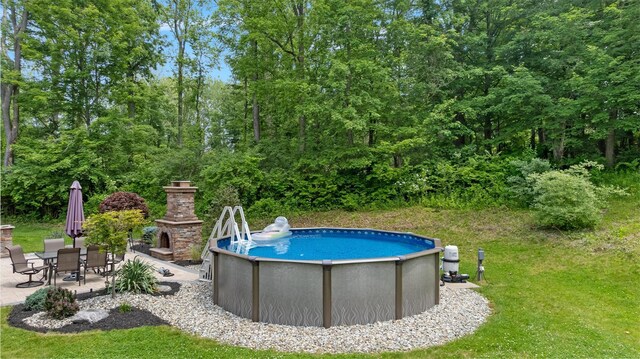 1 Hidden Hills Ct, Warwick, NY 10990 - swimming pool featuring a patio, an outdoor stone fireplace, and a lawn