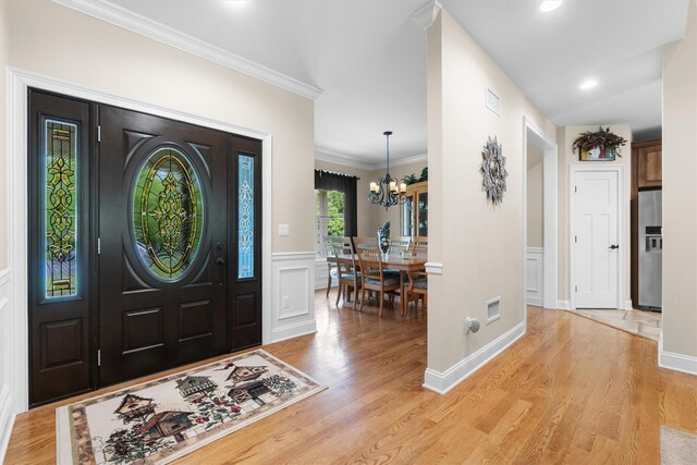 1 Hidden Hills Ct, Warwick, NY 10990 - entrance foyer featuring light wood-style floors, a wainscoted wall, a chandelier, ornamental molding, and a decorative wall