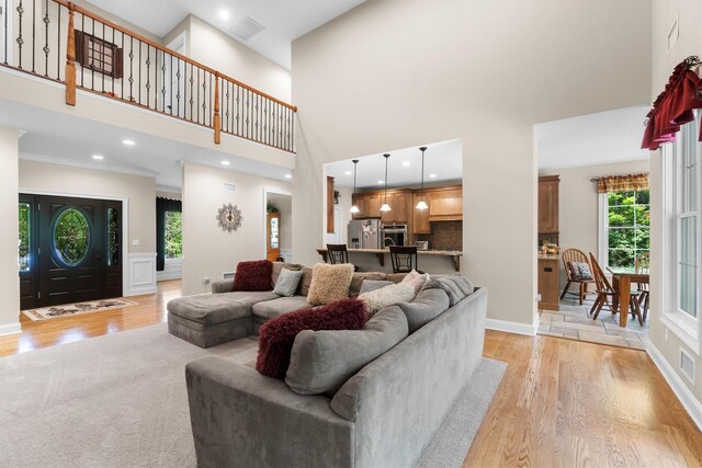 1 Hidden Hills Ct, Warwick, NY 10990 - living room with light wood finished floors, a towering ceiling, and ornamental molding