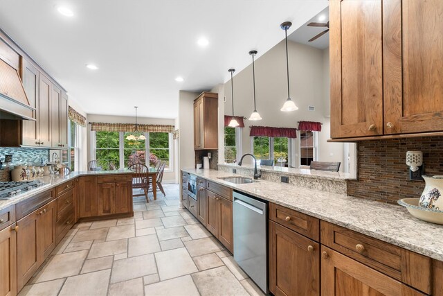 1 Hidden Hills Ct, Warwick, NY 10990 - kitchen featuring appliances with stainless steel finishes, decorative backsplash, ceiling fan, a peninsula, and hanging light fixtures