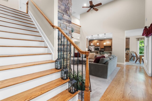 1 Hidden Hills Ct, Warwick, NY 10990 - stairway with a ceiling fan, wood finished floors, and a high ceiling