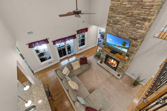 1 Hidden Hills Ct, Warwick, NY 10990 - living room featuring a fireplace, a high ceiling, a ceiling fan, and wood finished floors